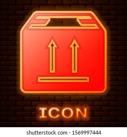 Glowing neon Cardboard box with traffic symbol icon isolated on brick wall background. Box, package, parcel sign. Delivery, transportation and shipping.  Vector Illustration