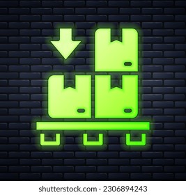 Glowing neon Cardboard boxes on pallet icon isolated on brick wall background. Closed carton delivery packaging box with fragile signs.  Vector