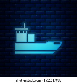 Glowing neon Cargo ship icon isolated on brick wall background.  Vector Illustration