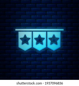 Glowing neon Carnival garland with flags icon isolated on brick wall background. Party pennants for birthday celebration, festival decoration.  Vector