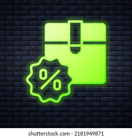 Glowing neon Carton cardboard box with discount percent tag icon isolated on brick wall background. Box, package, parcel sign. Delivery and packaging.  Vector