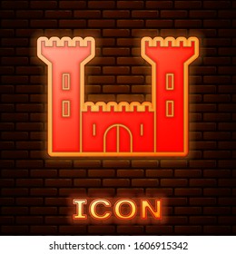 Glowing neon Castle icon isolated on brick wall background. Fortress sign.  Vector Illustration