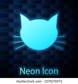 Glowing neon Cat icon isolated on brick wall background. Vector Illustration