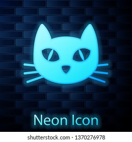 Glowing neon Cat icon isolated on brick wall background. Vector Illustration