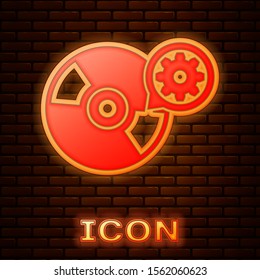 Glowing neon CD or DVD disk and gear icon isolated on brick wall background. Adjusting app, service concept, setting options, maintenance, repair, fixing.  Vector Illustration