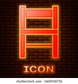 Glowing neon Chair icon isolated on brick wall background.  Vector Illustration