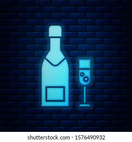 Glowing neon Champagne bottle and glass of champagne icon isolated on brick wall background. Merry Christmas and Happy New Year.  Vector Illustration