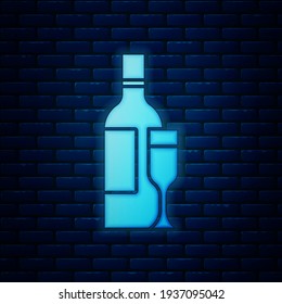Glowing neon Champagne bottle with glass icon isolated on brick wall background.  Vector