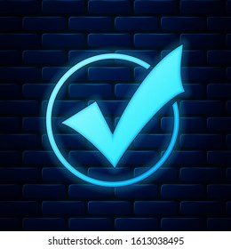 Glowing neon Check mark in round icon isolated on brick wall background. Check list button sign.  Vector Illustration