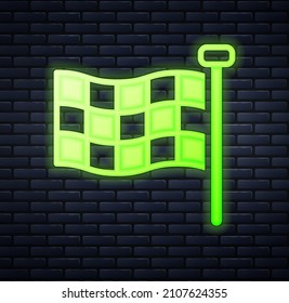 Glowing neon Checkered flag icon isolated on brick wall background. Racing flag.  Vector