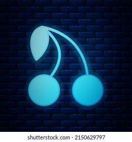 Glowing neon Cherry icon isolated on brick wall background. Fruit with leaf symbol.  Vector