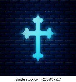 Glowing neon Christian cross icon isolated on brick wall background. Church cross.  Vector