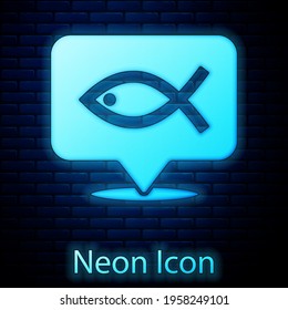 Glowing neon Christian fish symbol icon isolated on brick wall background. Jesus fish symbol. Vector