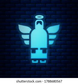 Glowing neon Christmas angel icon isolated on brick wall background.  Vector