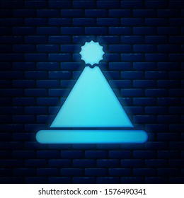 Glowing neon Christmas Santa Claus hat icon isolated on brick wall background. Merry Christmas and Happy New Year.  Vector Illustration