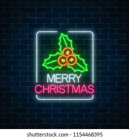 Glowing neon christmas sign with holly in rectangke frame on dark brick wall background. Christmas symbol web banner in neon style. Vector illustration. Bright signboard christmas label, logo.