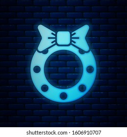 Glowing neon Christmas wreath icon isolated on brick wall background. Merry Christmas and Happy New Year.  Vector Illustration