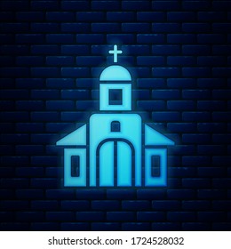 Glowing neon Church building icon isolated on brick wall background. Christian Church. Religion of church.  Vector Illustration