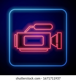 Glowing neon Cinema camera icon isolated on blue background. Video camera. Movie sign. Film projector.  Vector Illustration