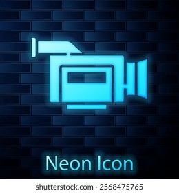 Glowing neon Cinema camera icon isolated on brick wall background. Video camera. Movie sign. Film projector.  Vector