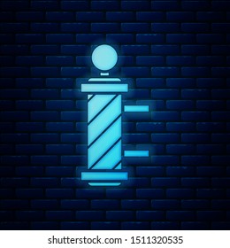 Glowing neon Classic Barber shop pole icon isolated on brick wall background. Barbershop pole symbol.  Vector Illustration