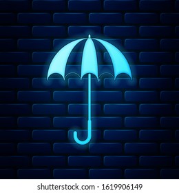 Glowing neon Classic elegant opened umbrella icon isolated on brick wall background. Rain protection symbol.  Vector Illustration