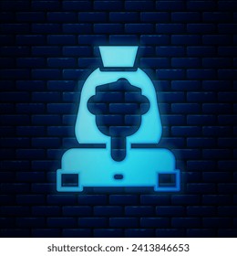 Glowing neon Cleaning lady service icon isolated on brick wall background.  Vector