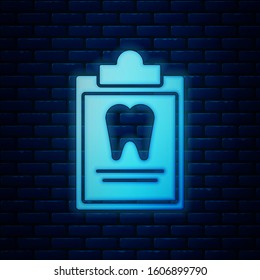 Glowing neon Clipboard with dental card or patient medical records icon isolated on brick wall background. Dental insurance. Dental clinic report.  Vector Illustration