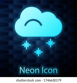 Glowing neon Cloud with snow icon isolated on brick wall background. Cloud with snowflakes. Single weather icon. Snowing sign. Vector Illustration