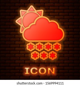 Glowing neon Cloud with snow and sun icon isolated on brick wall background. Cloud with snowflakes. Single weather icon. Snowing sign.  Vector Illustration