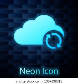 Glowing neon Cloud sync refresh icon isolated on brick wall background. Cloud and arrows. Vector Illustration