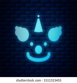 Glowing neon Clown head icon isolated on brick wall background.  Vector Illustration