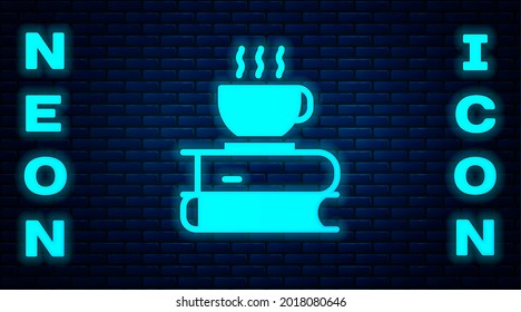 Glowing neon Coffee cup and book icon isolated on brick wall background. Tea cup. Hot drink coffee.  Vector Illustration