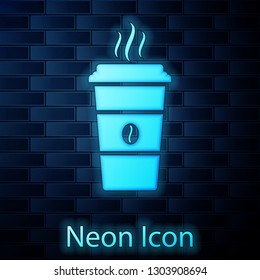 Glowing neon Coffee cup icon isolated on brick wall background. Disposable coffee cup with hot coffee. Vector Illustration