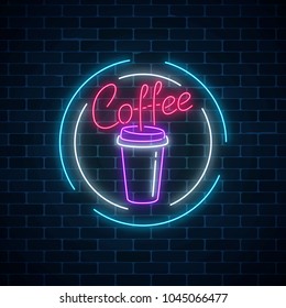 Glowing neon coffee cup sign on a dark brick wall background. Night advertisement symbol of coffee. Cafe or vendor machine emblem. Vector illustration.