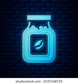 Glowing neon Coffee jar bottle icon isolated on brick wall background.  Vector