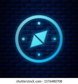 Glowing neon Compass icon isolated on brick wall background. Windrose navigation symbol. Wind rose sign.  Vector Illustration