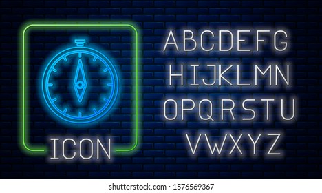 Glowing neon Compass icon isolated on brick wall background. Windrose navigation symbol. Wind rose sign. Neon light alphabet. Vector Illustration