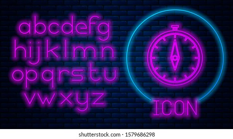 Glowing neon Compass icon isolated on brick wall background. Windrose navigation symbol. Wind rose sign. Neon light alphabet. Vector Illustration