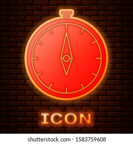 Glowing neon Compass icon isolated on brick wall background. Windrose navigation symbol. Wind rose sign.  Vector Illustration