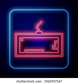 Glowing neon Computer keyboard icon isolated on blue background. PC component sign.  Vector Illustration