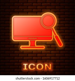 Glowing neon Computer monitor diagnostics icon isolated on brick wall background. Adjusting app, service, setting options, maintenance, repair.  Vector Illustration