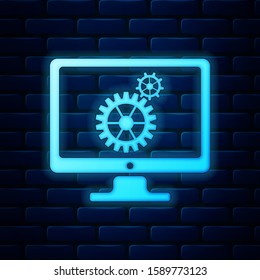 Glowing neon Computer monitor and gears icon isolated on brick wall background. Monitor service concept. Adjusting app, setting options, maintenance, repair, fixing concepts.  Vector Illustration