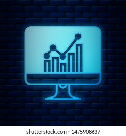 Glowing neon Computer monitor with graph chart icon isolated on brick wall background. Report text file icon. Accounting sign. Audit, analysis, planning.  Vector Illustration