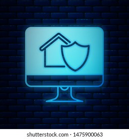 Glowing neon Computer monitor with house under protection icon isolated on brick wall background. Protection, safety, security, protect, defense concept.  Vector Illustration