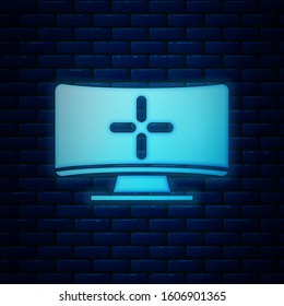 Glowing neon Computer monitor icon isolated on brick wall background. PC component sign.  Vector Illustration