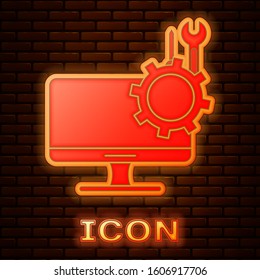 Glowing neon Computer monitor with screwdriver and wrench icon isolated on brick wall background. Adjusting, service, setting, maintenance, repair.  Vector Illustration