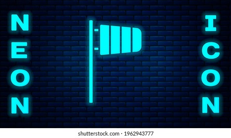 Glowing neon Cone meteorology windsock wind vane icon isolated on brick wall background. Windsock indicate the direction and strength of the wind.  Vector