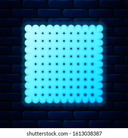 Glowing neon Cookie icon isolated on brick wall background. Pastry sing. Biscuit symbol.  Vector Illustration