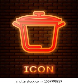 Glowing neon Cooking pot icon isolated on brick wall background. Boil or stew food symbol.  Vector Illustration